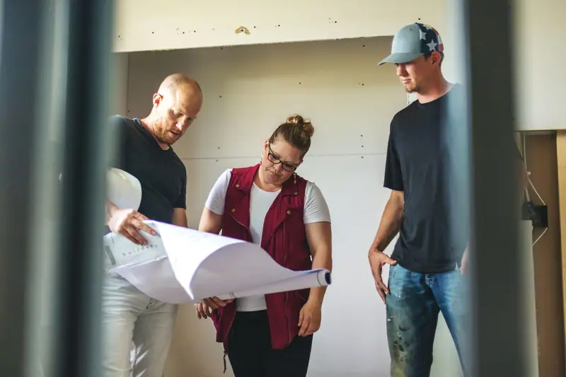Home Construction Staff Meeting and Reviewing House Plans
